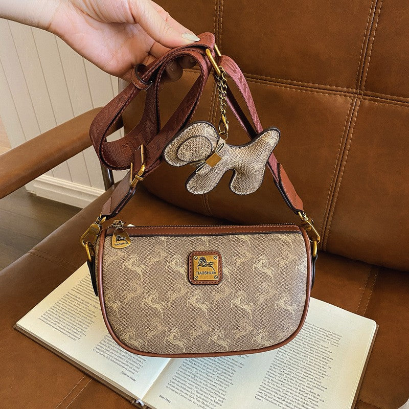 Classic style handbag with strap, featuring a shoulder-sling design, suitable for women, with a bag shape resembling